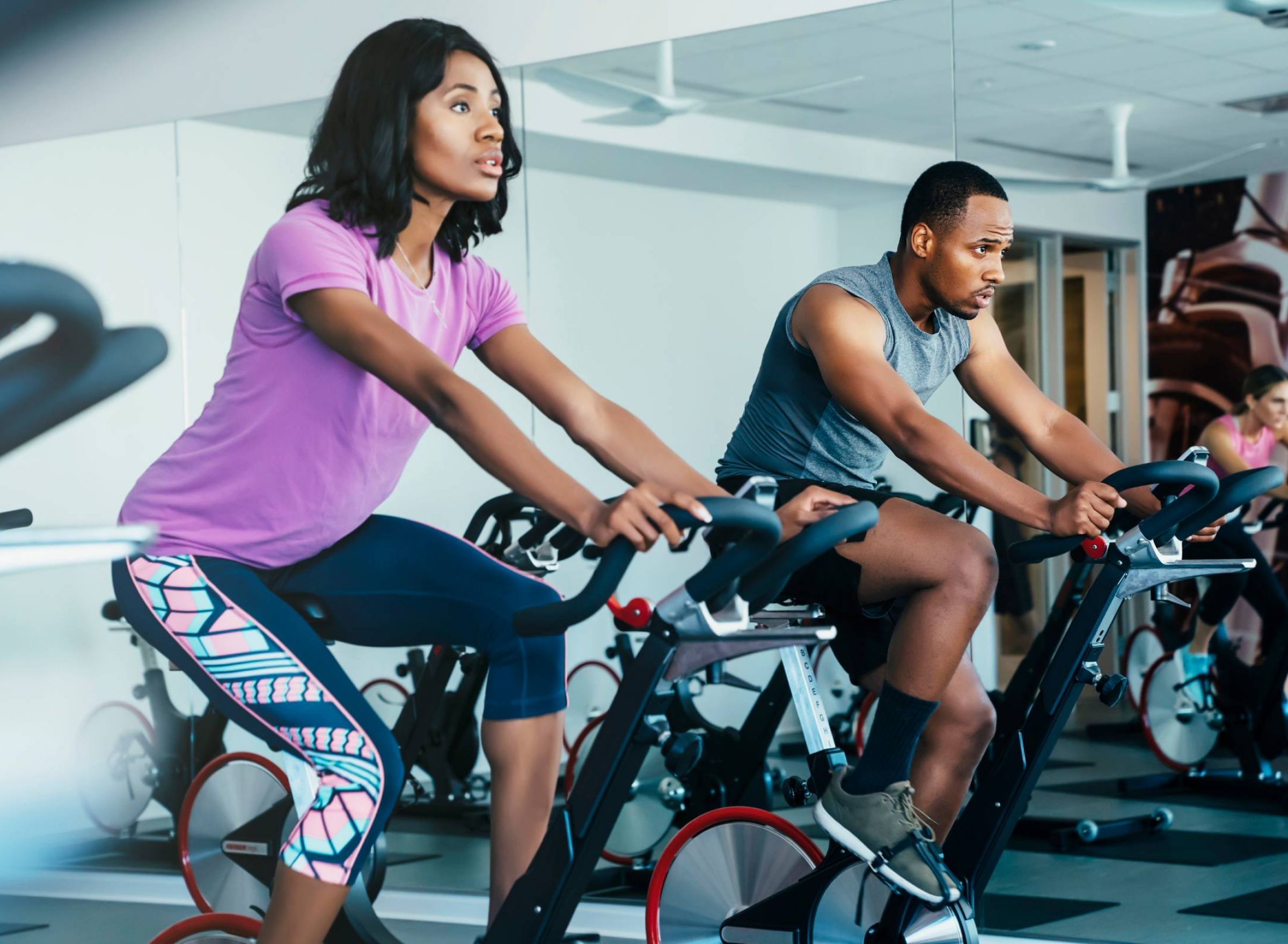 Monteverde with people cycling in a spin class in an apartment community fitness center