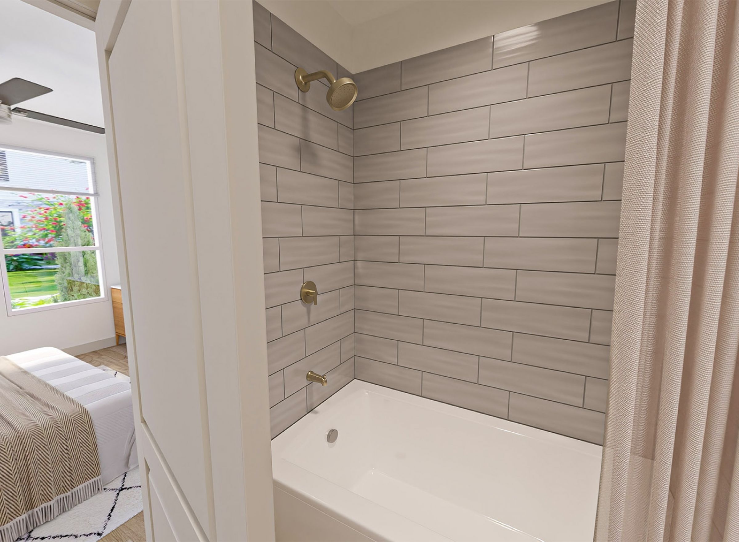 Monteverde Apartments Modern bathroom with gray subway tile shower, gold fixtures, and curtain partially open to a bedroom with a window.