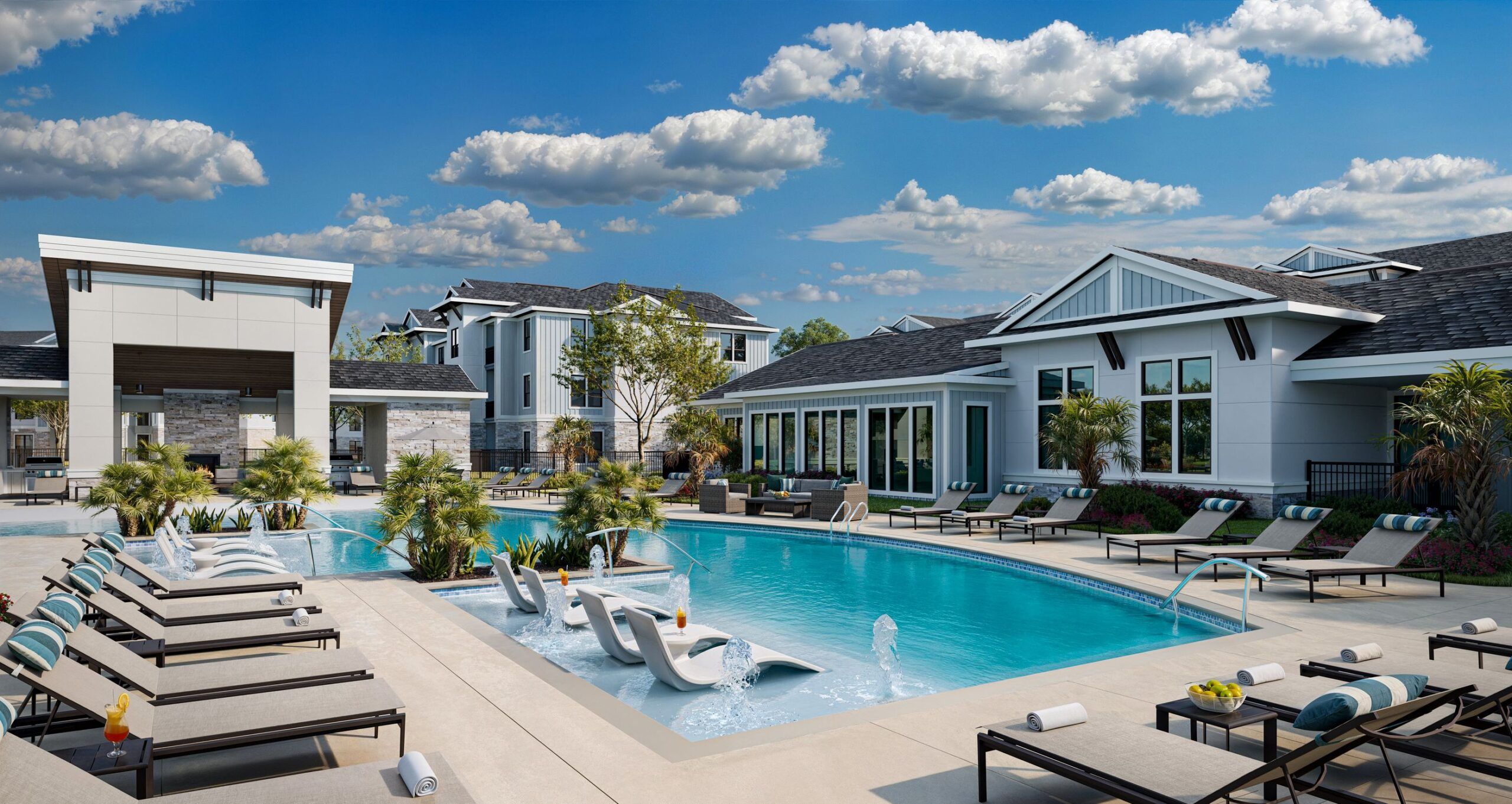 Resort-style outdoor pool with lounge chairs, in-water recliners, and modern buildings under a blue sky.